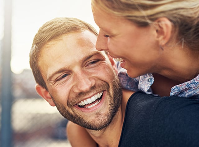 Nasmejan mlad par, ki se veseli in je zadovoljen po zdravljenju z zdravilom Canesten